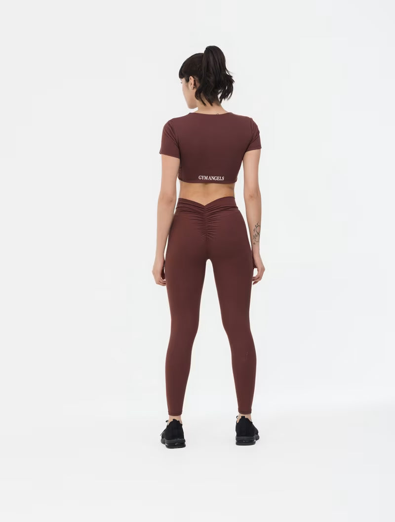 Girl Standing in Brown Short Sleeve Workout Crop Top with Twist Design UK