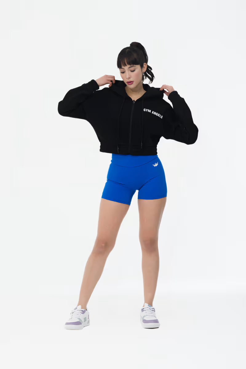 Black crop fleece hoodie styled with athleisure outfit indoors