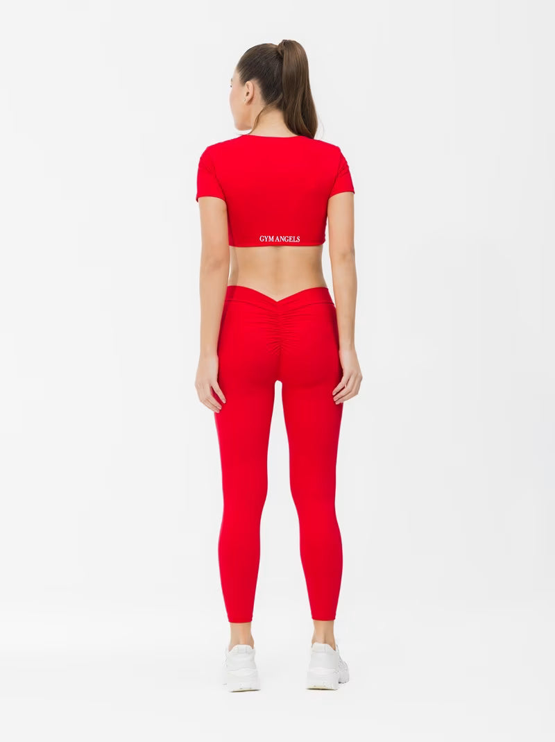Girl Standing in Red Short Sleeve Workout Crop Top with Twist Design UK